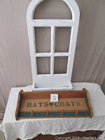 Pine hat and coat shelf with black 'HATS ♥ COATS' engraving and five pegs on front.