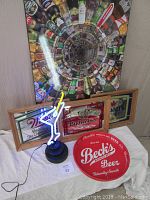 Photo showing full collection of beer decor including wooden backed poster, three beer mirrors, Beck's tray, and neon martini light