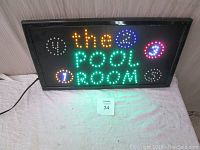 View of the illuminated LED pool room sign with colorful animated pool ball LEDs lit up.