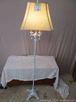 Full view of tall floor lamp with shade and 60 inch height.