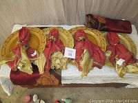 View of all items in the set arranged with charger plates, napkins with holders, placemats rolled and laid out, displayed together on a surface