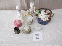 Photo of entire lot showing teapot, figurines, ring holders, pottery bowl, and toothpick holder.