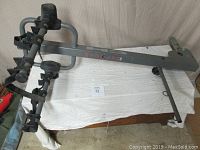 Angled view of full rack showing upright support arm, wheel trays and hitch attachment
