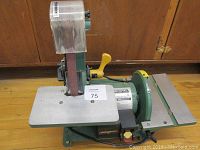 Full angled view of sander unit showing belt sanding surface, motor, and tables.