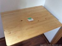 Top view of the wooden wall-mounted desk surface showing the natural wood grain and smooth finish.