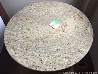 Top view of round granite table top showing natural granite pattern and texture.