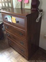 Side and front view of solid wood dresser showing wood grain, drawer fronts, and hardware.