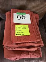 Folded colored sheet set with label listing included items and mention of bleach stain.