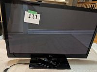 Front view of the 42-inch LG plasma TV showing the screen, stand, and attached power cord.