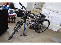 Full side view of the Diamondback mountain bike with tire pump standing in a garage.