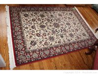 Full view of the Couristan area rug laid out on hardwood floor, showing overall pattern, colors, and fringes.