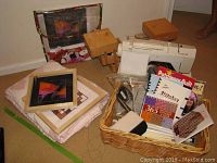 Full view of knitting basket, embroidery frames, sewing machine with foot pedal, hot glue gun and quilt.