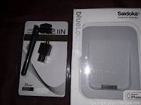 Photo shows USB llN 2.4 GHz wireless adapter with antenna next to the USB receiver in its packaging, beside the white Saidoka Bluelounge iPhone dock in box.