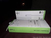 Two boxed Belkin Mini DisplayPort to HDTV cables, side by side on a dark surface.