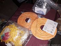 Two orange coil-style paper lanterns, a set of yellow plastic cookie cutters with plastic cookie-shaped pieces, and a box labeled Animal Cookie Cutter