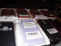 Overview of various phone cases laid out on a surface, showing different colors and packaging.