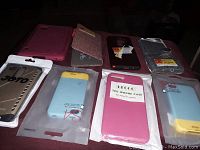 Photo of 8 various phone cases including folio types and packaged cases, showing colors and material variety.