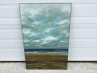 Abstract plaque style wall art standing upright, showing full front image with moody sky and landscape color palette