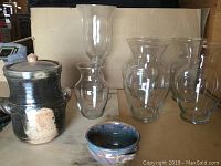 Photo showing the Muskoka Day Pottery candy dish jar with lid, four glass vases and a small bowl in front.