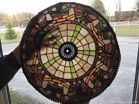 Top-down view of stained glass shade showing central medallion and overall pattern