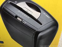 Close-up photo of the black Flowers P-35C paper shredder showing control panel and sheet input slot.