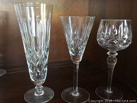 Photo showing 3 types of crystal stemware glasses: tall beer glass, slender white wine glass, and rounded red wine glass with detailed cut pattern.