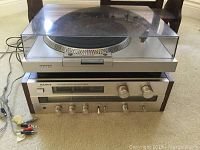 Front view of turntable with dust cover closed and receiver beneath