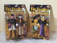 Two McFarlane Toys The Beatles Yellow Submarine action figure packages side by side, showing unopened searing and colorful character designs