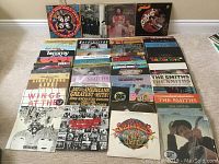 Group shot of vinyl LP sleeves arranged in rows on floor