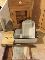 Lot contents showing all items grouped: cabinet, enamel bowls, first aid kit box, washboard mirror