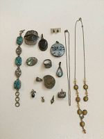 Full lot of sterling silver jewelry with turquoise bracelet, pendants, ring size 7, earrings, and necklace with yellow stone accents