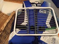 Close-up of white plastic dish rack with metal rods placed on top of life jacket.