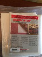 Photo of Magic-Stop rug underlay pad in its original packaging showing product label and size 3x5 feet (90x152 cm)