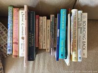 View of 10 self-help and mindfulness books arranged upright showing spines with titles and authors visible.