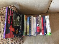Image showing 15 books laid out on a couch with topics on self-help, coaching, mindfulness, psychology, and therapy.