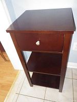 Front and side view of brown MDF side table showing drawer and shelves