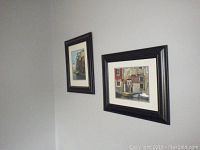 Two framed Venetian travel photos hanging on a corner wall, showing complete frames and matting.