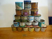 Photo of stacked assorted tobacco tins showing brands Players, Club, Old Port, MacDonald's, Cameo, Picobas, Matinée, Sweet Caporal.