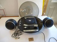 Wide view of the Electrohome Apollo 860 phonograph with open plastic dust cover and two detachable spherical speakers showing connected cords.