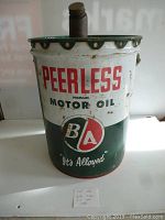 Front view of the 5 gallon B/A Peerless Motor Oil can showing logo and text.