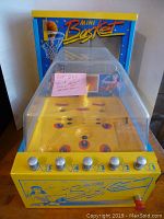Full front view of yellow and blue Mini Basket unit with clear dome and backboard graphic