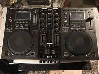 Top view of Gemini CDM-3700G karaoke player showing dual jog wheels, LCD screens, buttons, and control knobs.