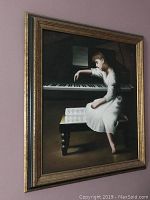 Photo showing the full framed painting of a girl sitting on a bench playing piano with sheet music in front.