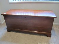 Front view of wooden Lane cedar chest with lock keyhole visible and scratched surface.