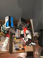Box contents include Nerf gun, DVDs, car model, picture frames, and miscellaneous items as shown from above.