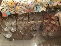 Overview of all 21 pieces grouped by type on a table including water glasses, small and large wine glasses, and striped tumblers.