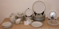 Full view of stacked Vintage St Regis Fine China set including plates, bowls, cups, saucers, plus white soup bowl