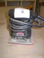 Photo of Jobmate electric sander showing front view with power cord wrapped