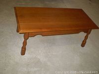 Top view of the solid wood coffee table showing the deliberate split down the middle of the table top.