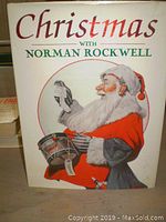 Cover of the Christmas with Norman Rockwell hardcover book showing Santa Claus illustration by Norman Rockwell.